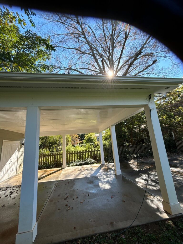 cleaning and washing the concrete surfaces under a covered area with pressure washing techniques