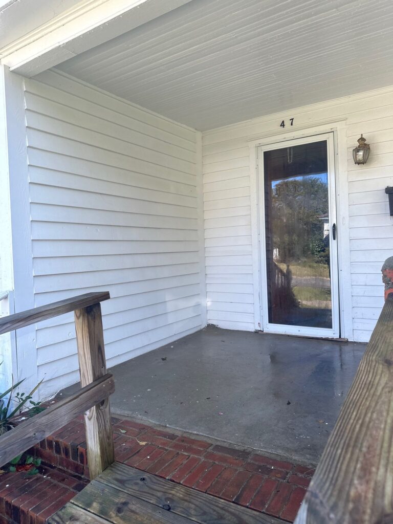 cleaning of the concrete porch and wooden steps to remove dirt and stains for improved appearance and maintenance