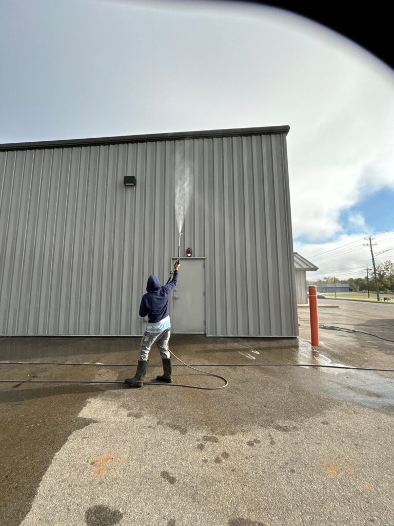 cleaning the exterior metal siding of a commercial building using pressure washing techniques