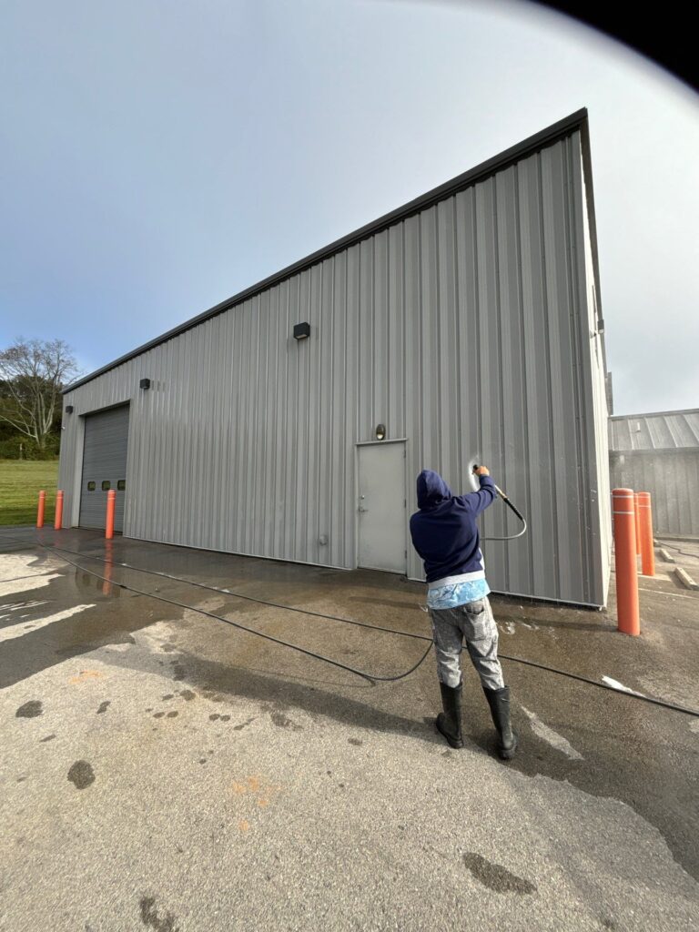 the service being done is pressure washing the exterior of a metal building and cleaning the surrounding pavement area