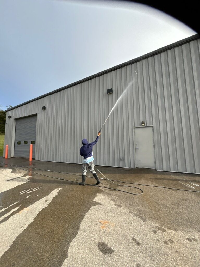 the service being performed is pressure washing the exterior metal wall and surrounding concrete surface of a commercial building