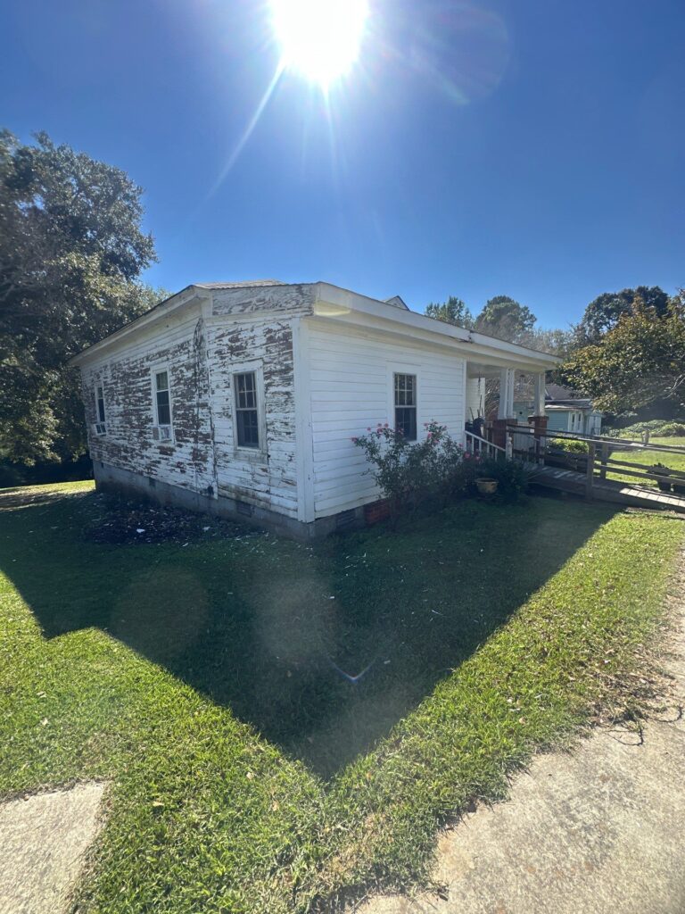 the service involves cleaning the exterior of a weathered house removing peeling paint and dirt from the surface